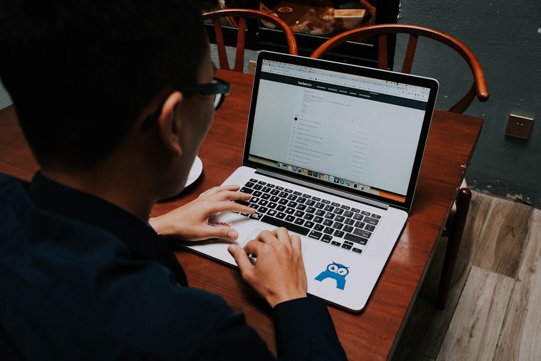 person coding on laptop