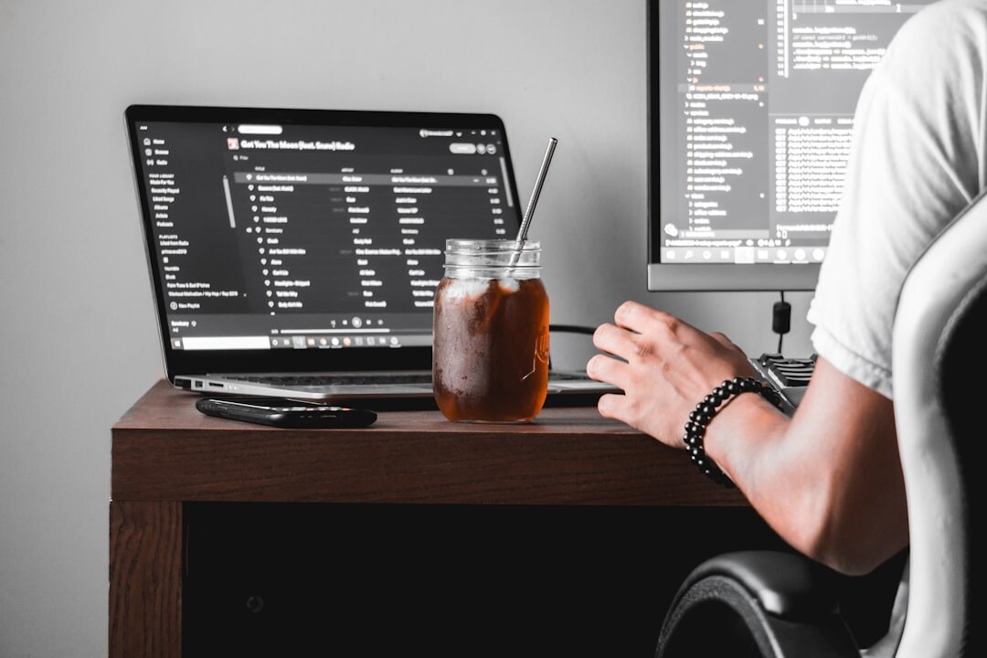 programmer coding on laptop