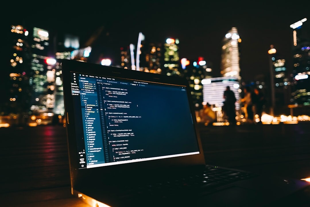 programmer coding on laptop