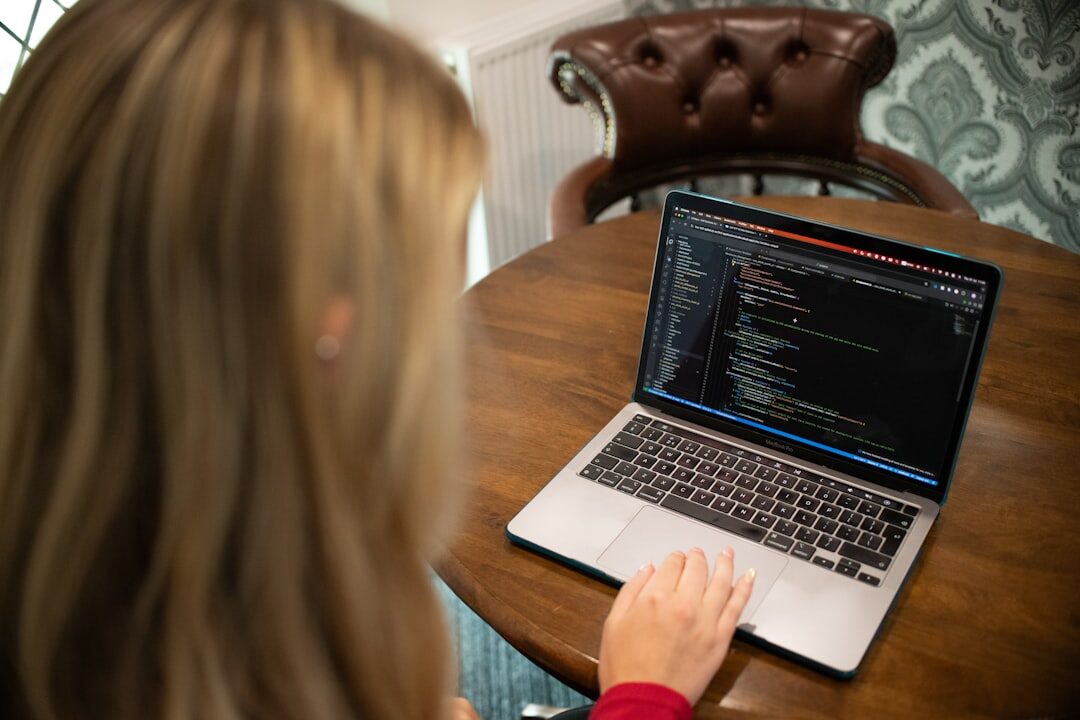 programmer coding on laptop