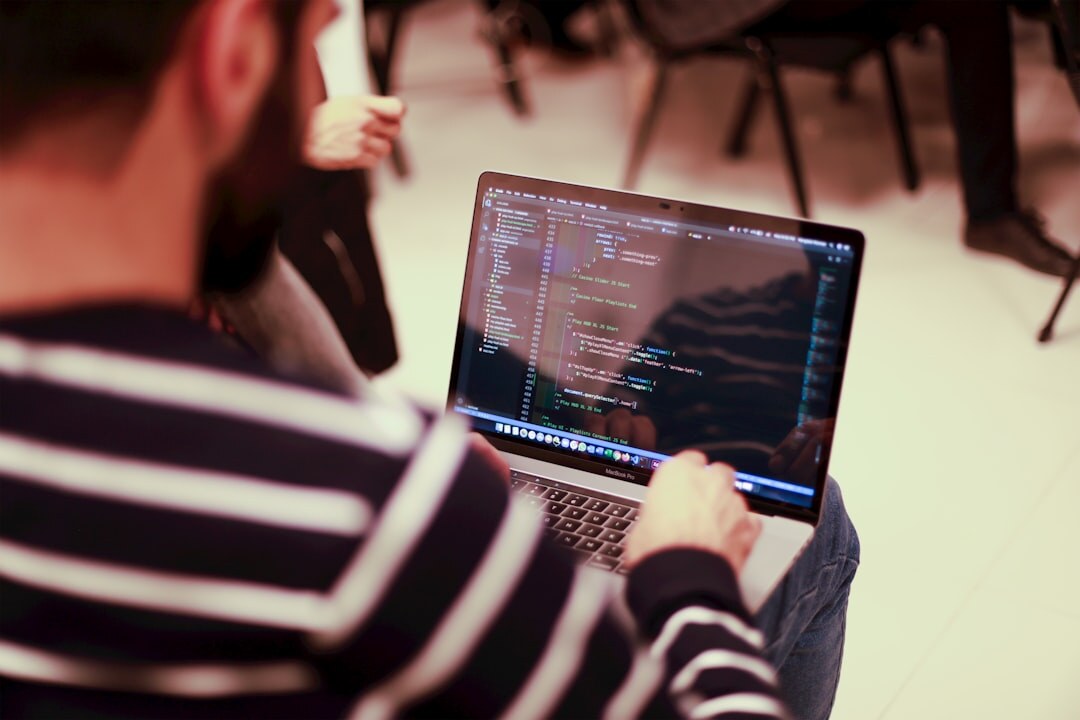 web developer coding on laptop